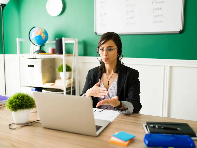 Instructor on a video call at her desk, available to discuss missed coursework and late-work options.